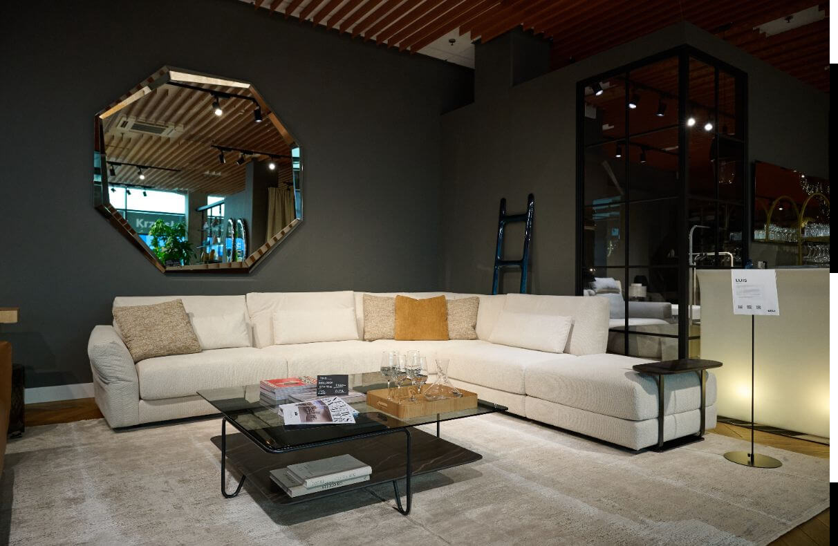 Model Luis powstał z potrzeby stworzenia sofy, która łączy w sobie dwie pozornie przeciwstawne wartości: techniczną precyzję i emocjonalne doświadczenie komfortu. Projekt definiuje równowaga między formą a uczuciem - to mebel, który nie tylko dopasowuje się do ciała, ale współgra z jego rytmem, pozwalając w pełni zanurzyć się w chwili spokoju. Pełna, osadzona przy ziemi bryła Luis emanuje stabilnością i pewnością. Jej forma została zaprojektowana tak, by budzić poczucie bezpieczeństwa, a jednocześnie subtelnie zapraszać do odpoczynku. Regulowane podłokietniki umożliwiają zmianę charakteru mebla – w pozycji prostej zachowuje klasyczną, niemal architektoniczną elegancję, natomiast przy lekkim wygięciu nabiera lekkości i współczesnej dynamiki. Ten detal, określany przez zespół projektowy mianem „efektu śmigła”, wydobywa z projektu energię ruchu i elegancką nonszalancję. W projekcie Luis skupiliśmy się na redefinicji komfortu: po raz pierwszy zbudowaliśmy go bez użycia pierza, tworząc wrażenie miękkości oparte wyłącznie na konstrukcji i technologii wypełnień. Nazwa Luis nie jest przypadkowa. To imię, które kojarzy się z ponadczasową klasą, spokojną siłą i naturalną elegancją. Luis to to wyraz dbałości o detal - o komfort, który nie epatuje luksusem, lecz tworzy go w codzienności.