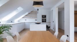 elegancki biały apartament na poddaszu z drewnianymi elementami projektu pracowni Komon Architekti