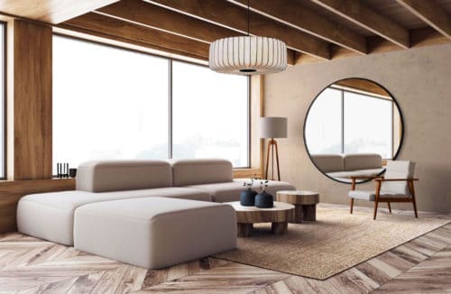 minimalistyczna przestrzeń z prostą bryłą szarej kanapy przy lampie na trójnogu