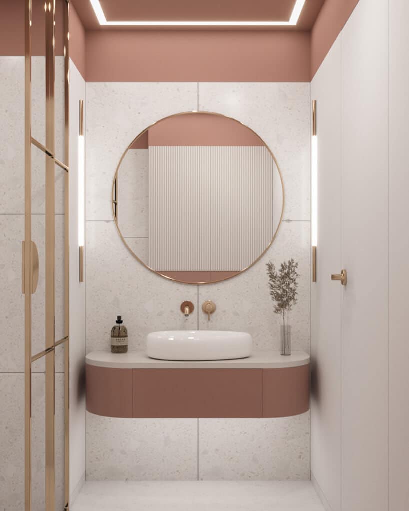 białe kafle w jasne pudrowo różowej łazience z okrągłym lustrem