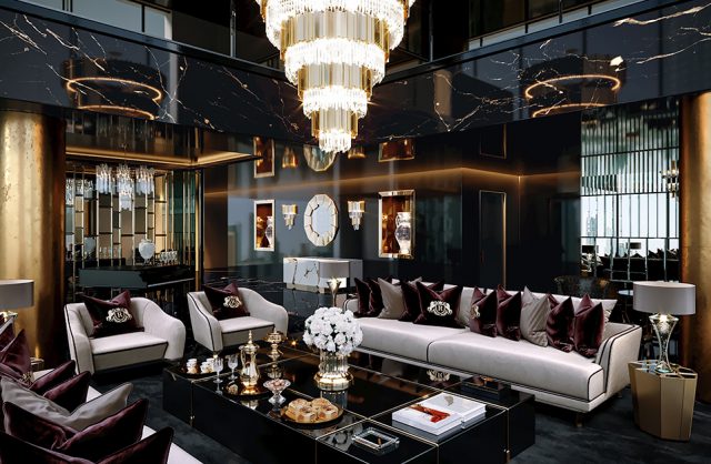 luksusowe wnętrze apartamentu w Dubaju od Covet House czarno-złoty salon z białą dużą sofą i dużym złotym żyrandolem