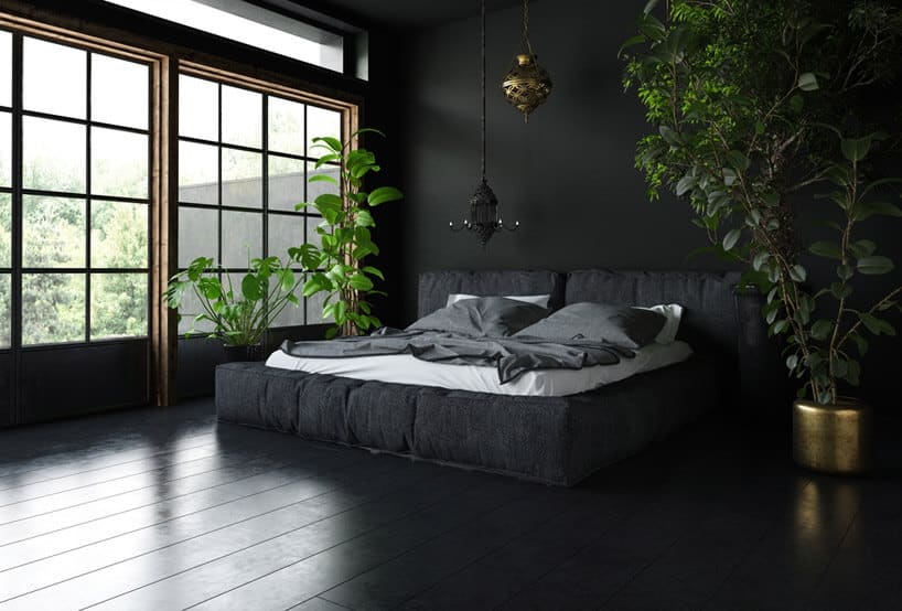 czarne łóżko podłoga ściana i okna zielone drzewka