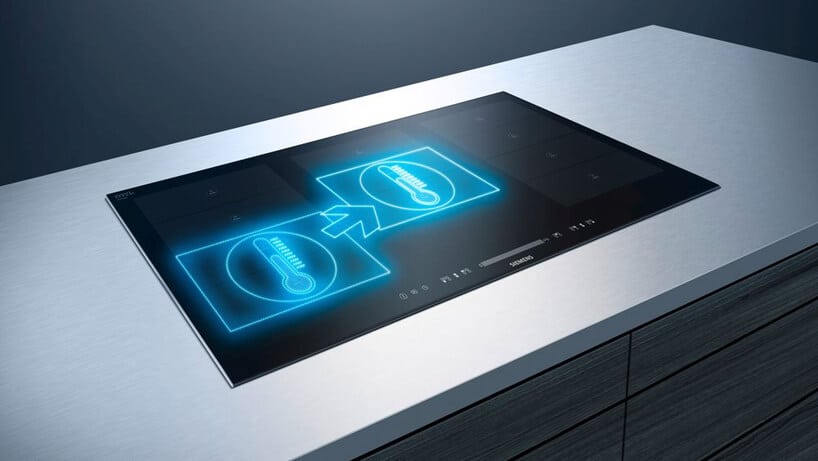 nowoczesna płyta grzewcza Siemens z prezentacją funkcjonalności w jasnym blacie wyspy kuchennej