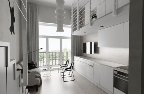 projekt minimalistycznego loftu Piotra Skorupskiego ze Studia Architektury biała kuchnia połączona z salonem