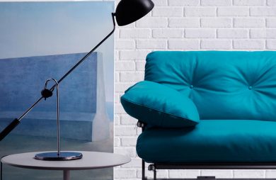 niebieska sofa z czarną lampą