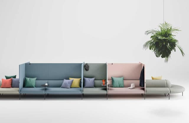 długa kolorowa sofa z podziała oraz różnokolorowymi poduszkami