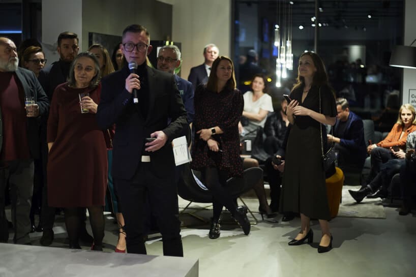 mężczyzna jeden z prowadzących 20-lecie BoConcept w Polsce na tle gości