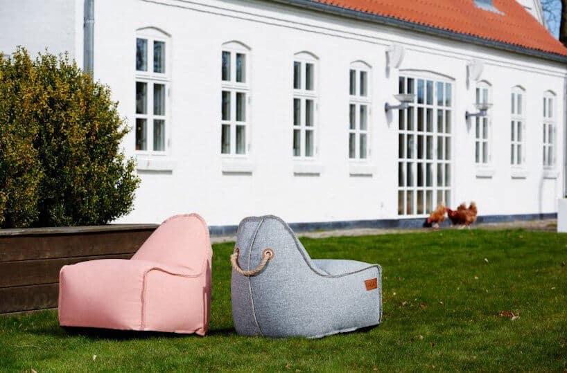 szara i różowa zewnętrzna pufa RETROit Cobana od Sack It w ogrodzie na tle białego budynku