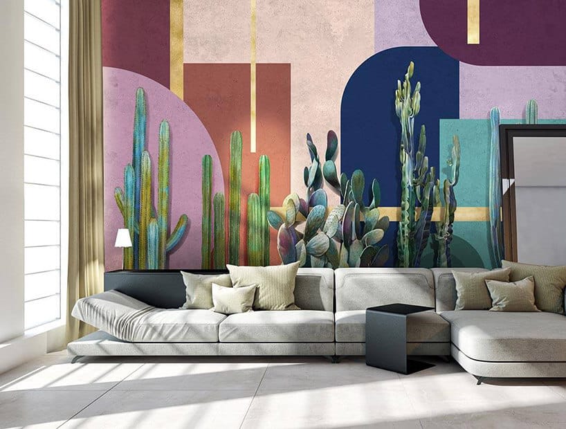 duża sofa na tle tapety kaktusami i figurami geometrycznymi
