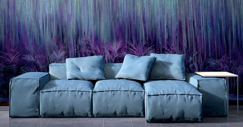 niebieska sofa na tle tapety z motywem fioletowych traw