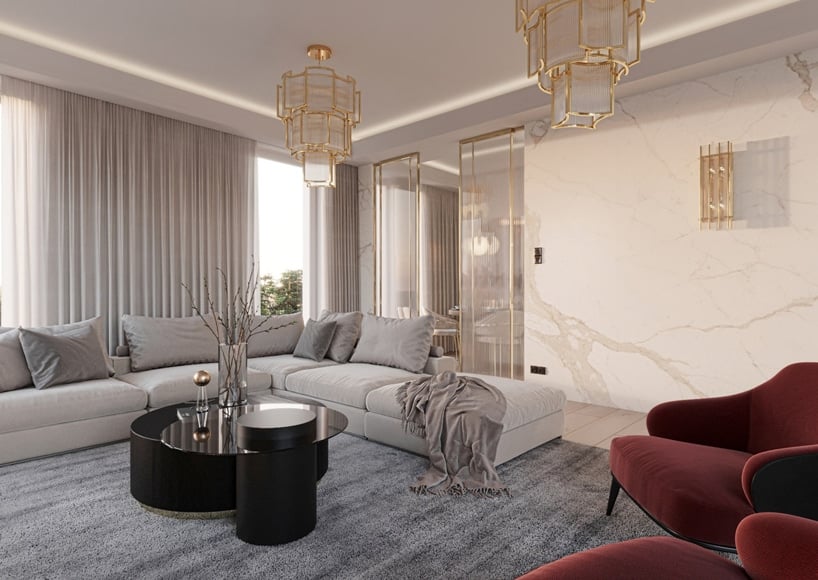 wnętrze eleganckiego apartamentu duża jasno szara narożna sofa przy czarnym niskim okrągłym stoliku