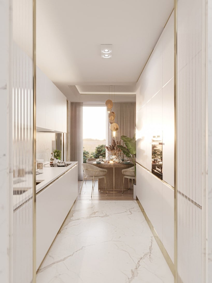 wnętrze eleganckiego apartamentu elegancka biała kuchnia ze złotymi akcentami i kamienną białą podłogą
