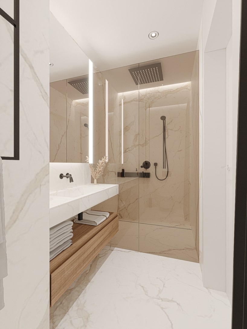 wnętrze eleganckiego apartamentu biała kamienna łazienka z dużym prysznicem za szybą