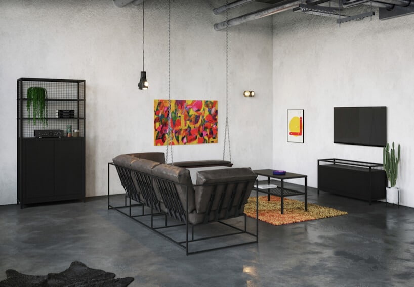 industrialne wnętrze z białymi ścianami i szarą betonową podłogą z z czarną sofą i siedziskiem podwieszonym na łańcuchach