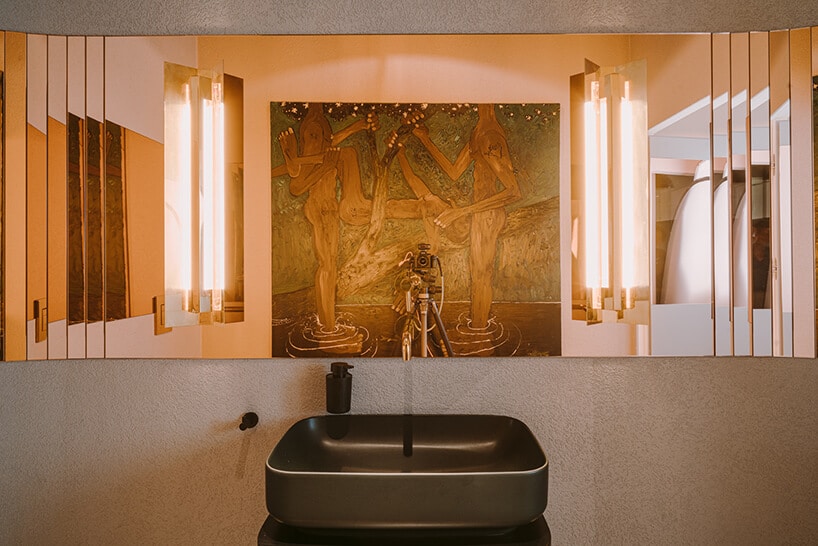 elegancka łazienka z ciemną umywalką i lustrem z miedzianym odbiciem w kreatywnym wnętrzu CLAY.WARSAW