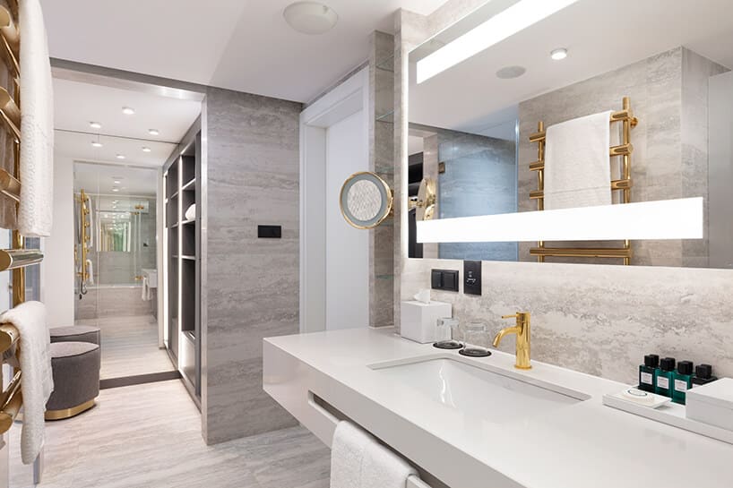 hotel Sofitel aranżacja apartamentu z elegancką szarą łazienką i złotymi dodatkami