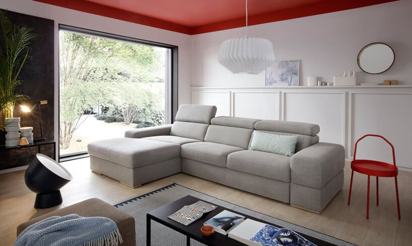 System modułowy Plaza od Gala Collezione szara sofa z podnoszonymi zagłówkami w białym nowoczesnym salonie z dużym panoramicznym oknem