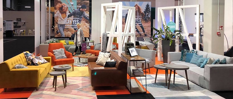 żółta sofa przy małych stolikach obok żółtego fotela