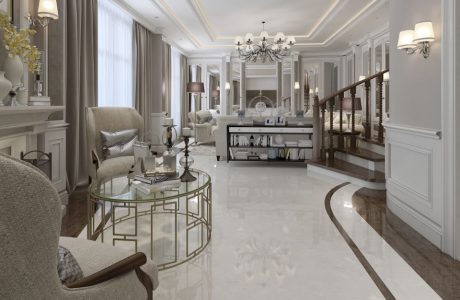 eleganckie białe wnętrze z biała kamienną podłogą z brązowym pasem pod ścianami wyjątkowym okrągłym stolikiem ze złotych metalowych prostokątów