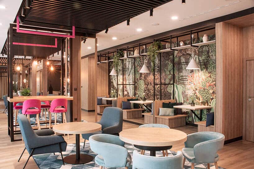 ibis Styles Santorini hotelowa restauracja z fotelami i stolikami i różowym krzesłem w tle