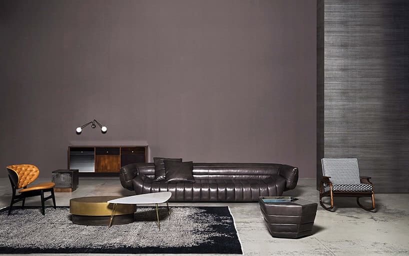 duża czarna skórzana sofa w ciemnej aranżacji salonu